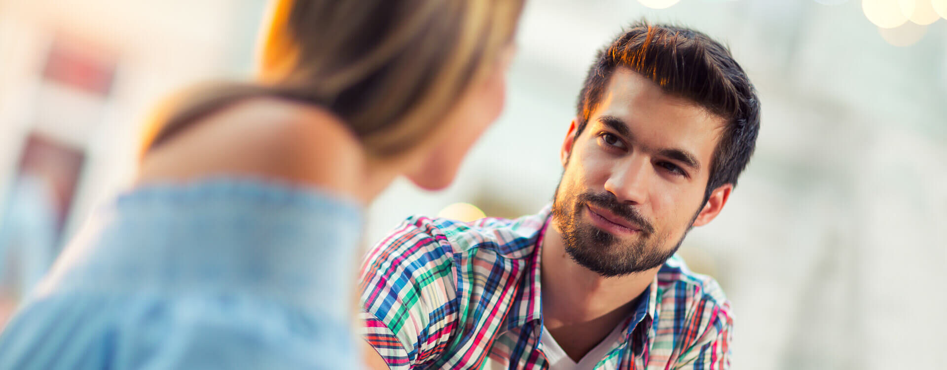 Young man and woman conversing with each other