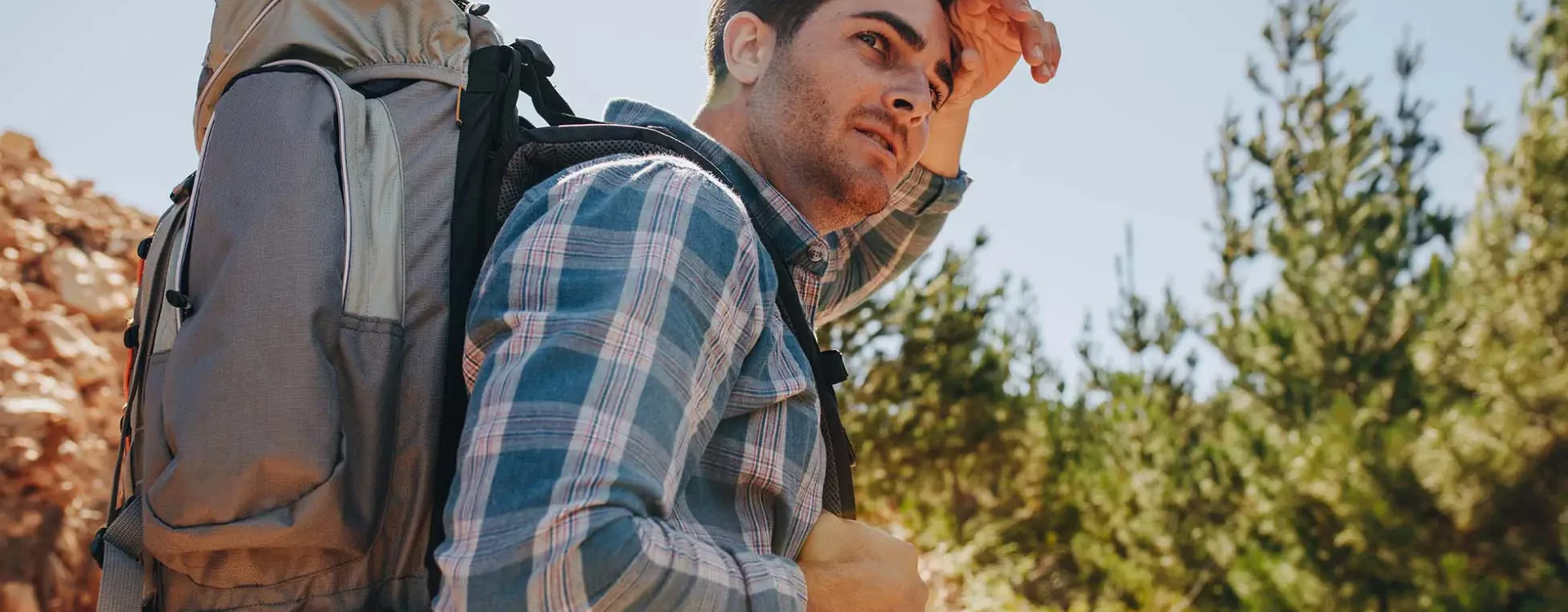 Man outdoors hiking with a backpack