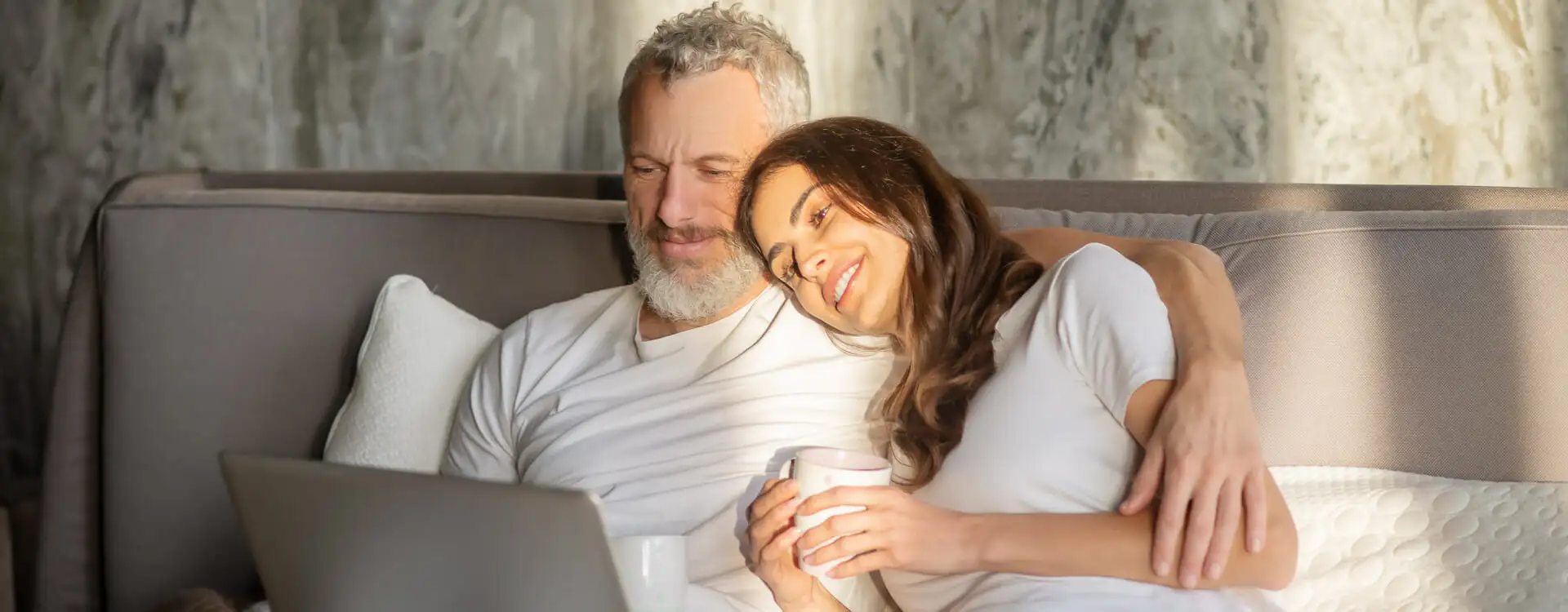 Man and wife reading together in bed