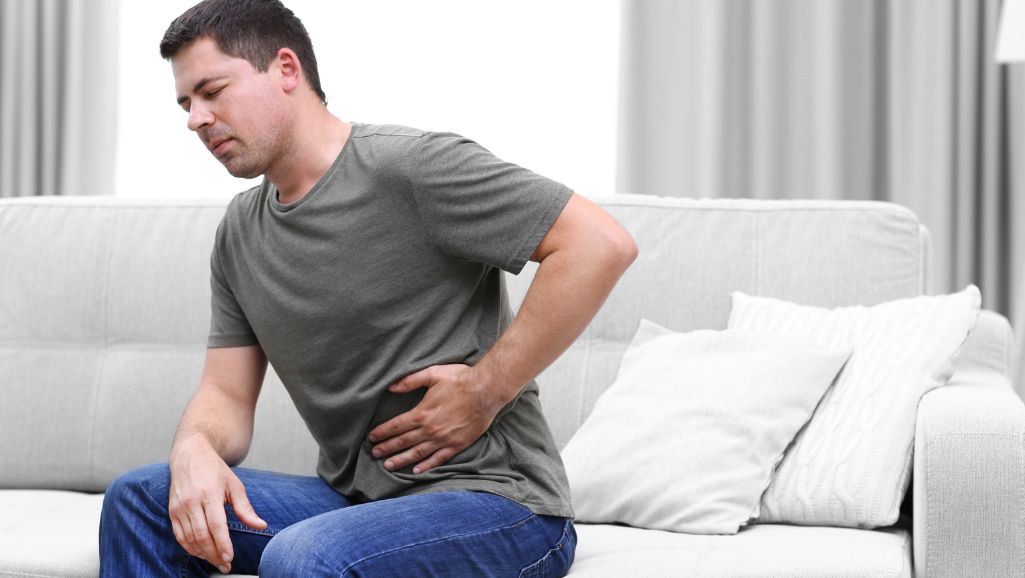 man with stomach pain needing treatment from low T clinic