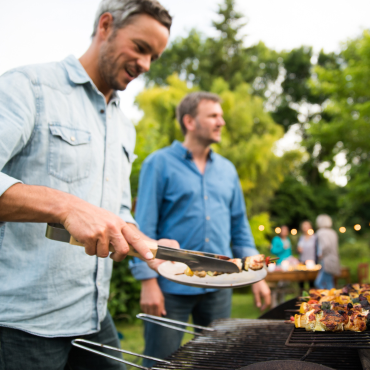 man grilling with friends
