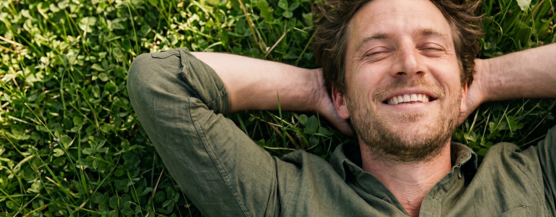 men relaxing in a field of grass, relieved he no longer has low testosterone