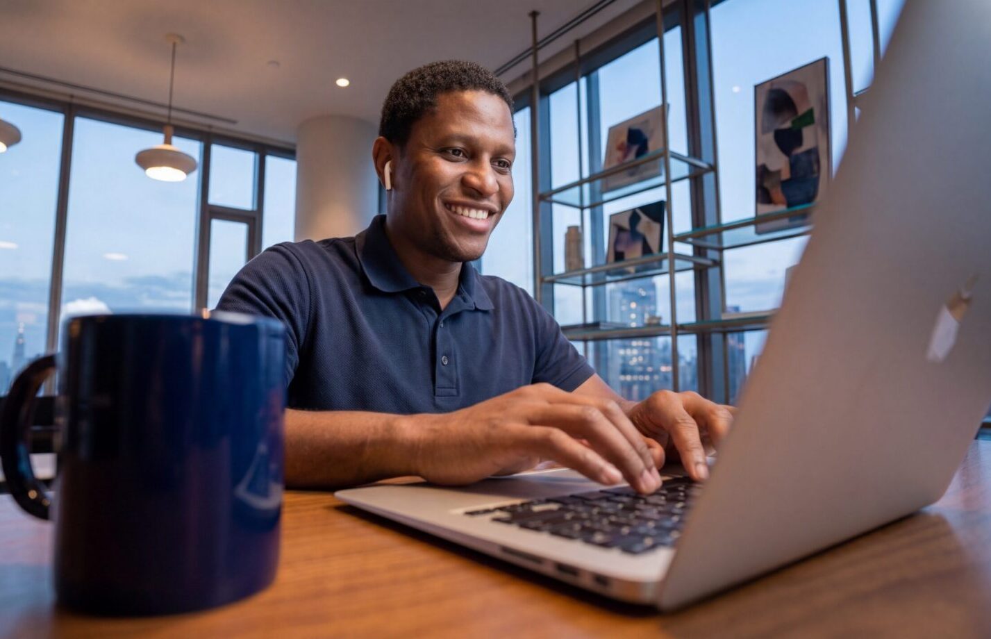Man smiling at his laptop after a productive day — mood changes and low testosterone